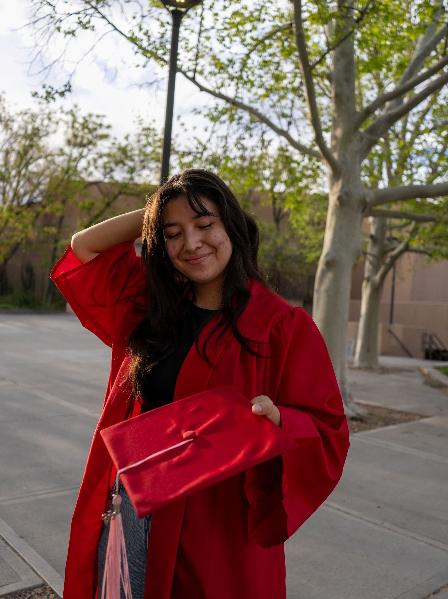 a unm graduate playing with her hair