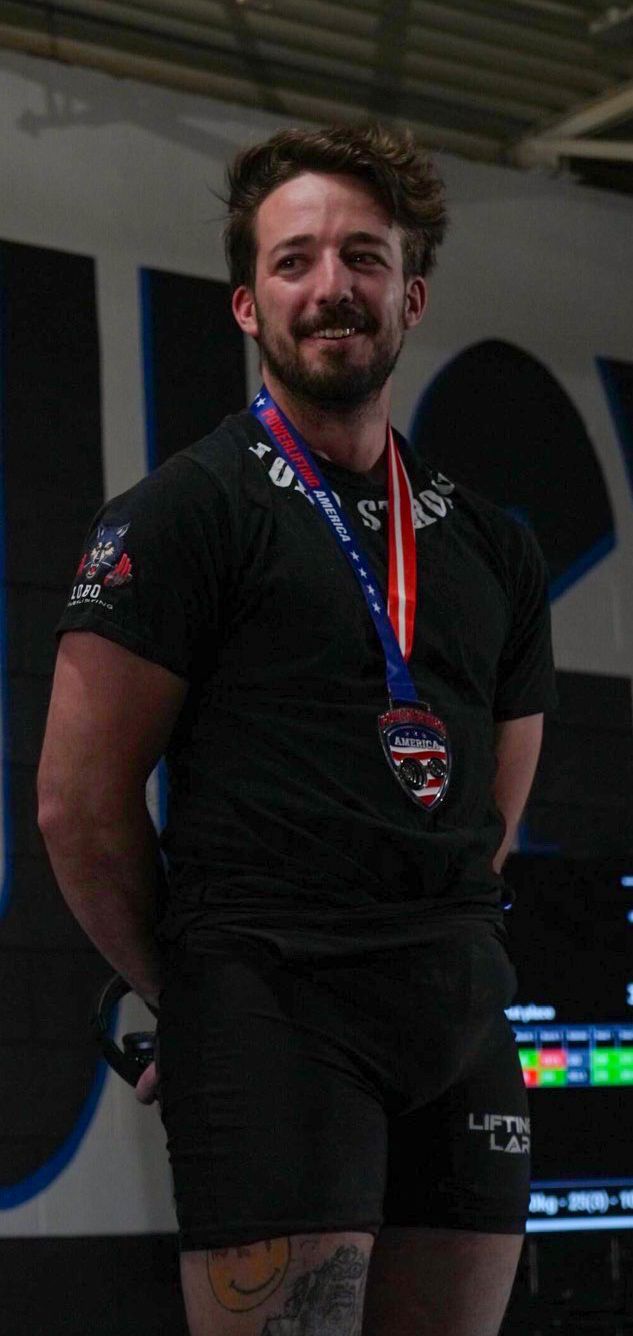 a powerlifter being awarded a medal