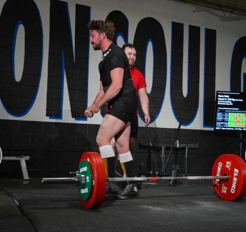 a powerlifter walking away from a bar