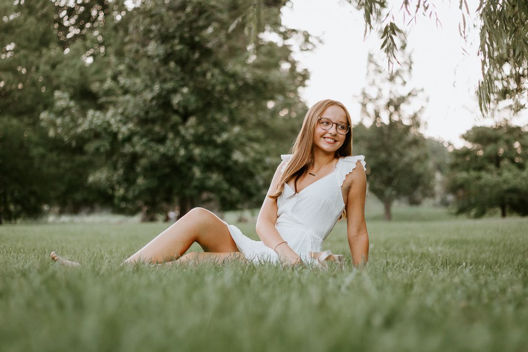 Sequence of portraits laid out horizontally showing reclining poses in grass with soft natural lighting and outdoor setting.