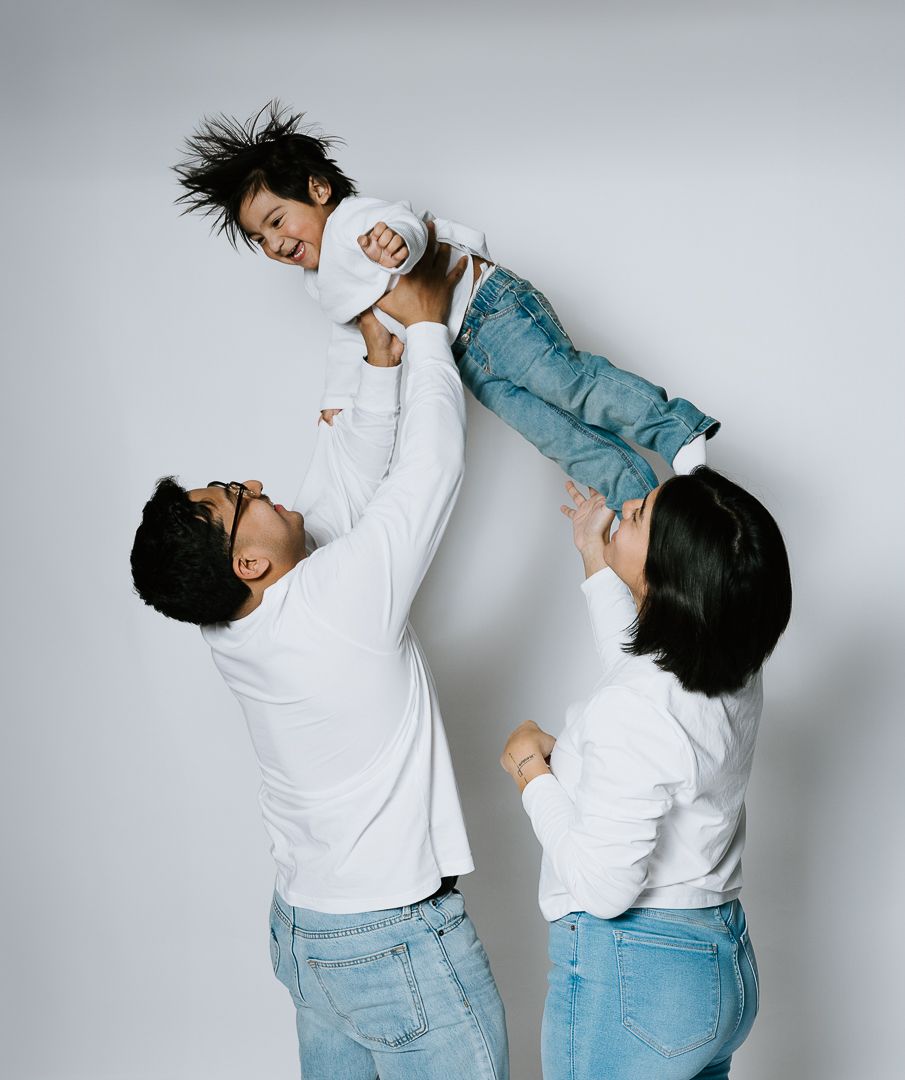 Four sequential photos show a person in a white shirt and jeans performing dynamic dance-like movements against a gray background.