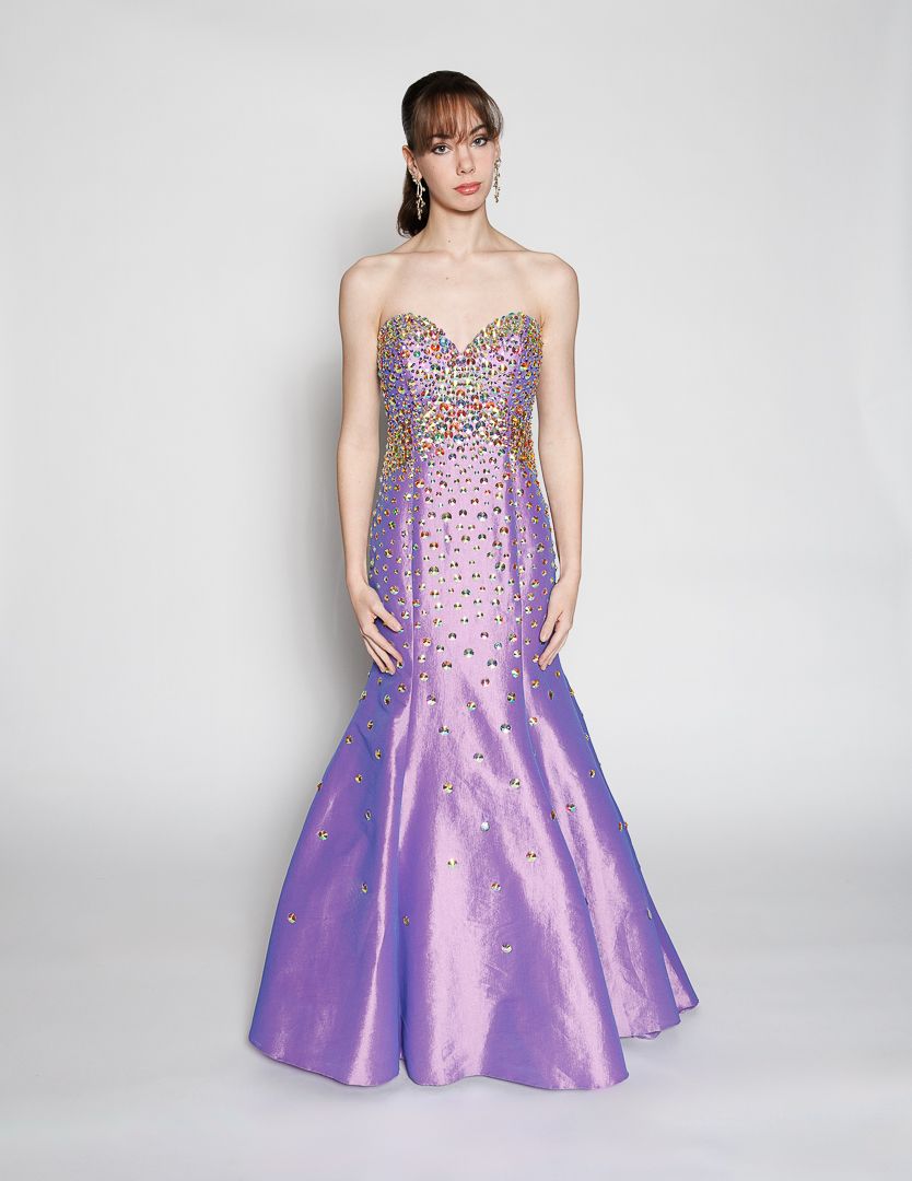Purple strapless mermaid gown with multicolor crystal embellishments on the fitted bodice.