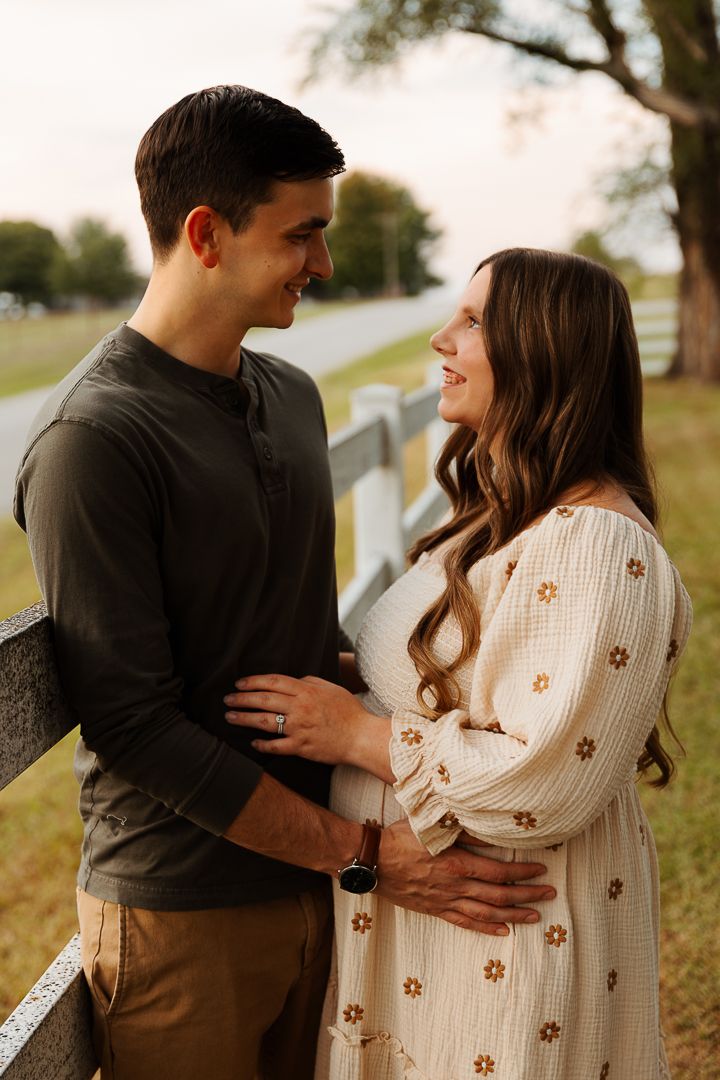 A couple embraces outdoors in autumn wearing coordinated casual outfits with a brown and white color scheme.