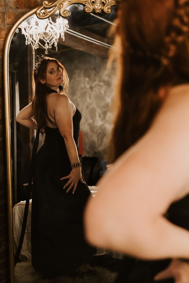 A moody series of photos showing a person in a black dress posing against a dark background with dramatic lighting.
