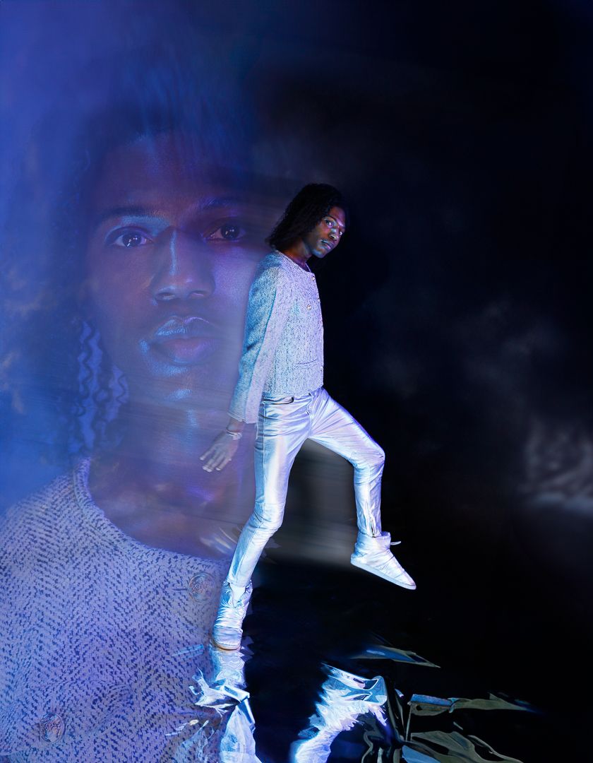 Multiple exposure photo showing movement against dark background with blue lighting effects.