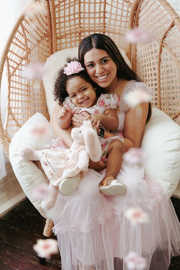 Sweet moments captured of people in white tulle dresses with pink flower petals.