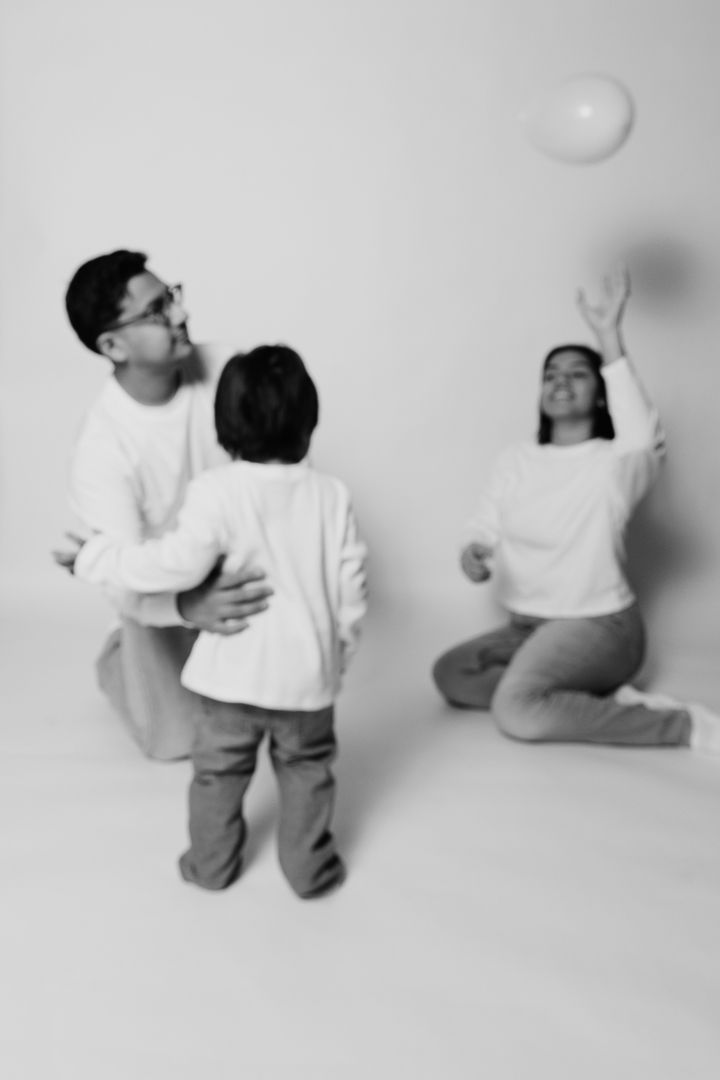 A sequence of black and white photos showing a person in white shirt and dark pants reaching up to touch a wall.