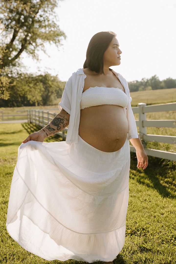 A sequence of maternity photos showing a woman in a white dress twirling in a sunlit field with a wooden fence.