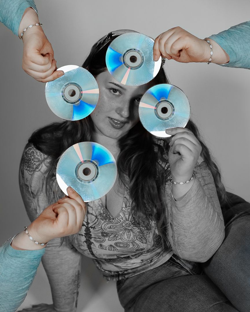 Creative photo sequence holding compact discs in front of face with selective color treatment.