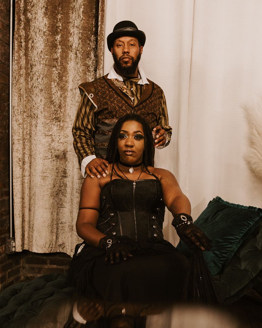Vintage-inspired boudoir photoshoot with dark dramatic lighting and costumes.