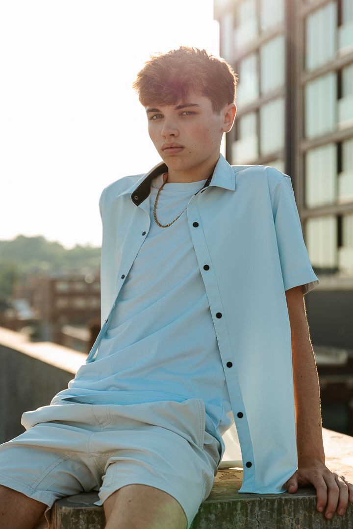 A collection of photos in soft light showing someone wearing a light blue button-up shirt against a sunlit backdrop.