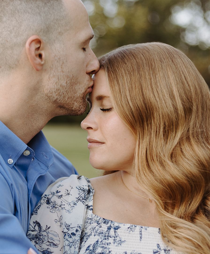 Romantic close up series showing a couple in dappled sunlight, with one wearing a floral print and one in blue.