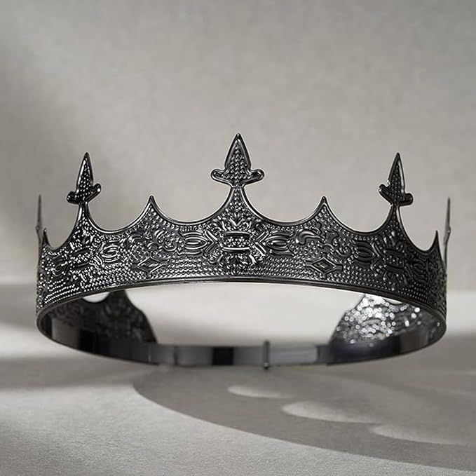 Black gothic-style crown with ornate engraved filigree patterns and fleur-de-lis spikes, displayed on a soft gray background.