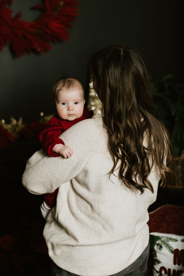 Moody indoor portraits showing tender moments between parent and child.