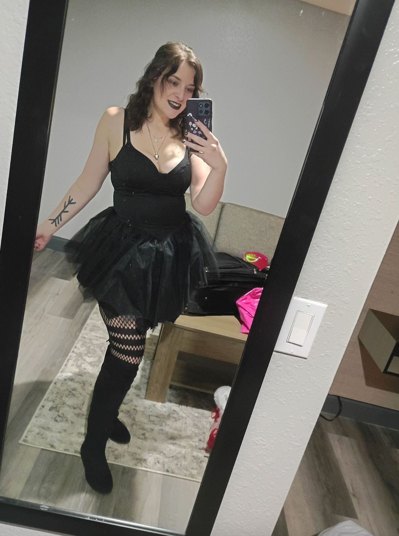 A series of mirror selfies showing someone in black clothing posing in what appears to be a dressing room.