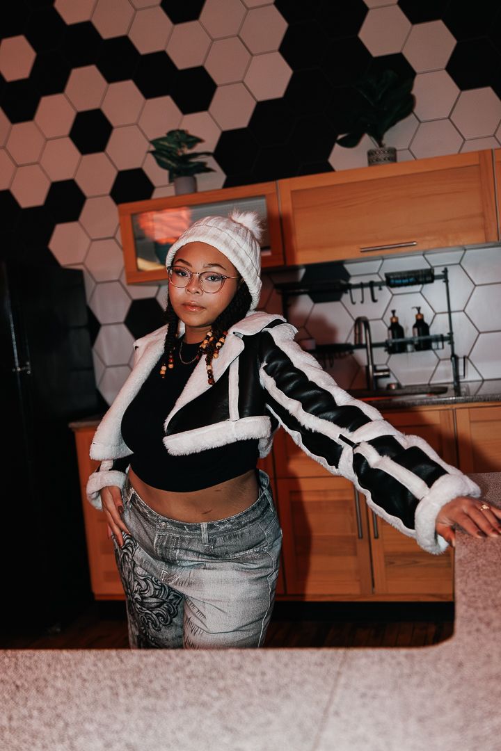 Dynamic poses showing street style fashion against hexagonal wall pattern.