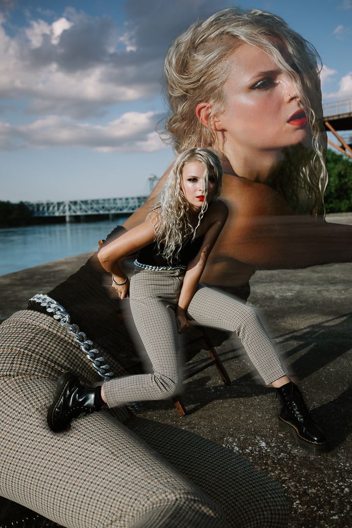 Dramatic portrait series of model in checked outfit against waterfront industrial setting with moody sky.
