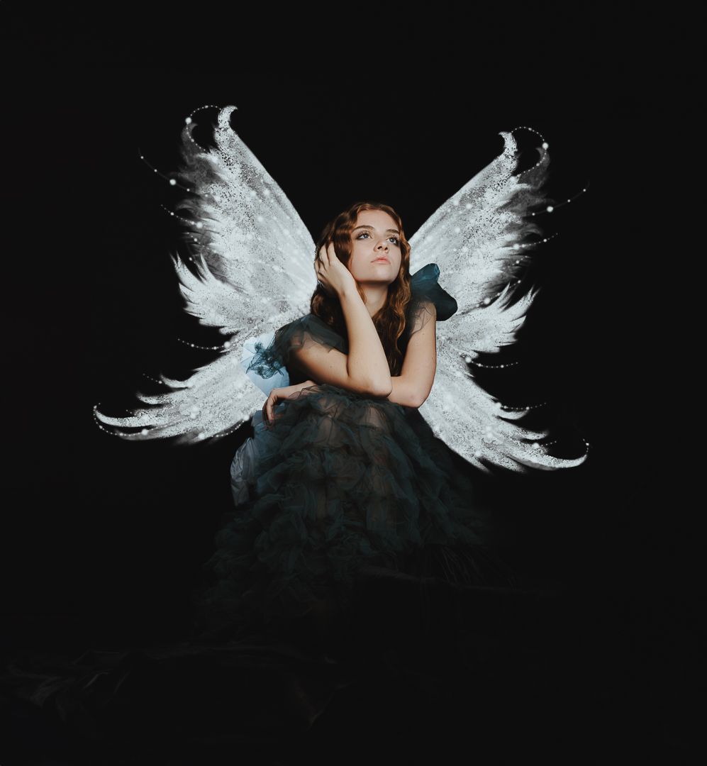 Artistic portrait series with ethereal white wings against a dark background in dramatic lighting.