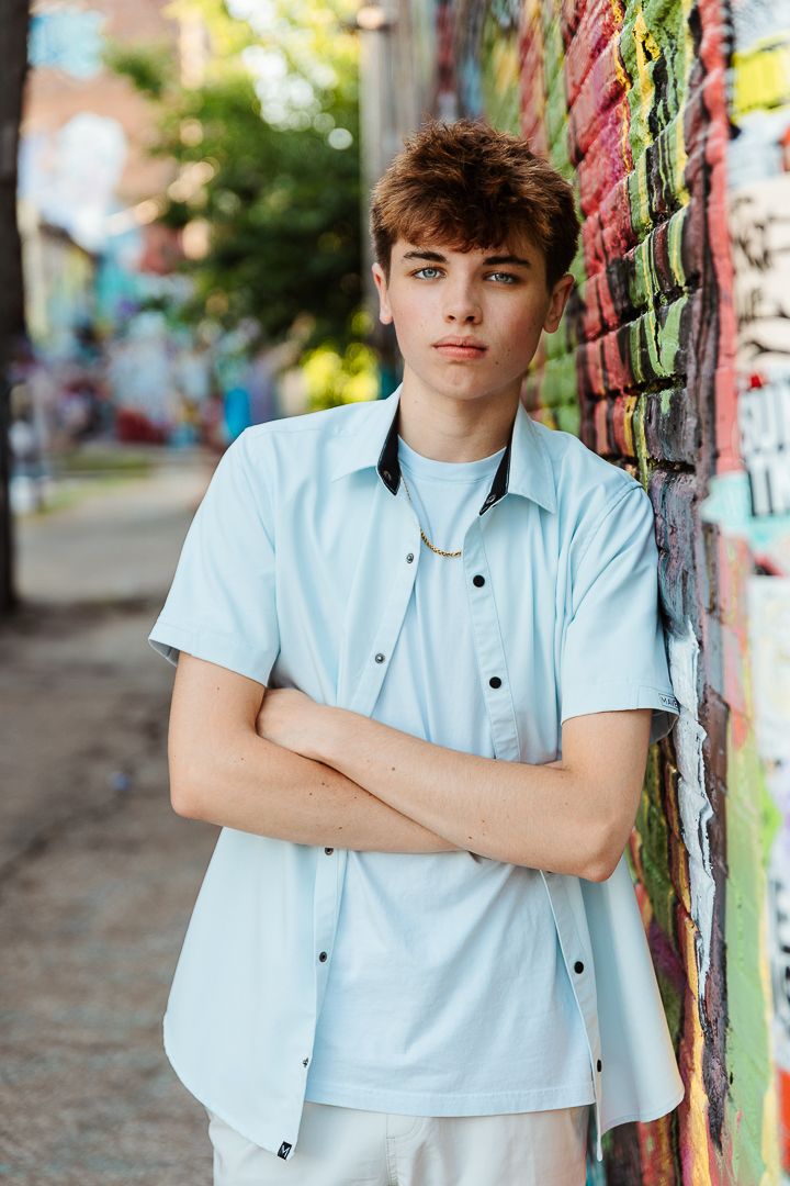 Series of casual fashion portraits showing model in light blue shirt against vibrant street art background.