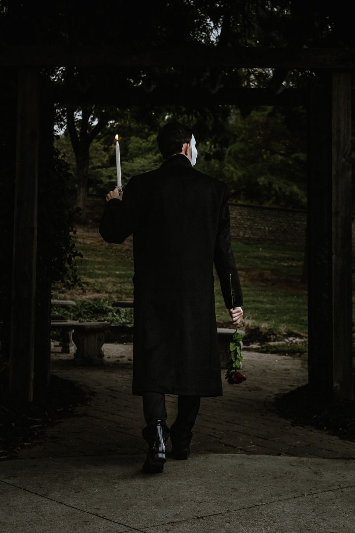 A dark and moody series of photos showing a person in black clothing walking through a dimly lit forest path.
