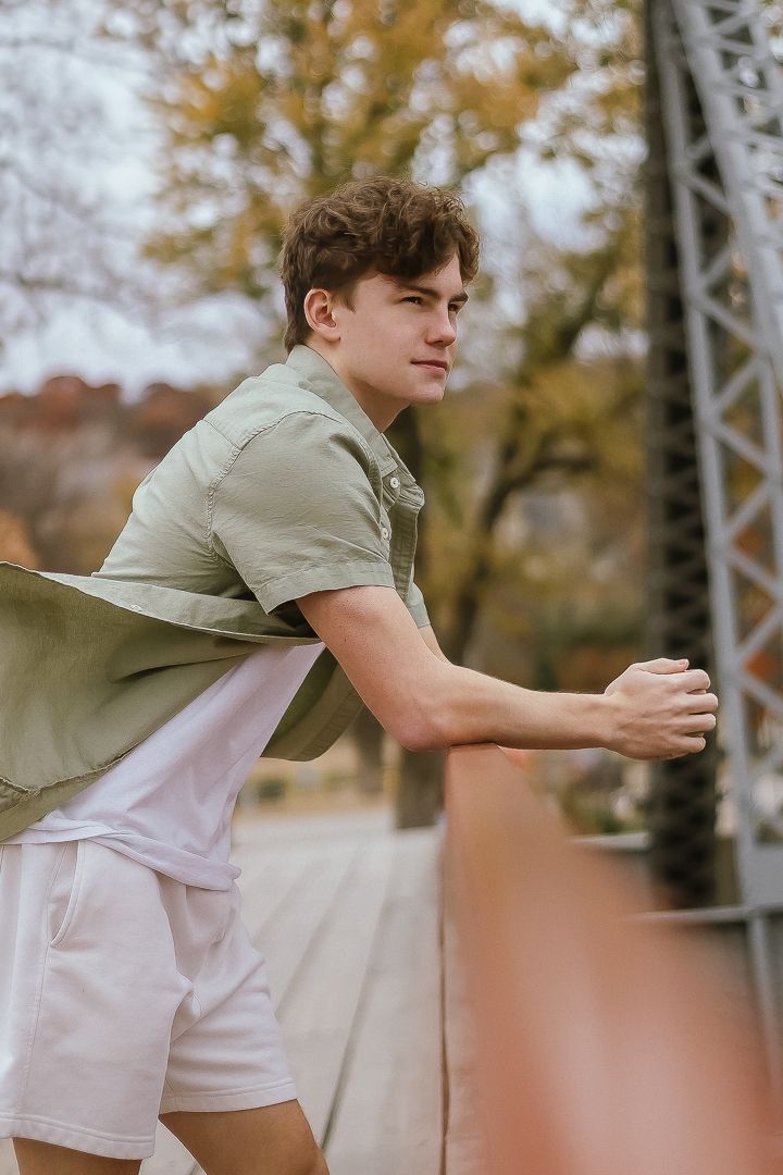 A person in casual attire poses outdoors near trees in autumn, creating a dynamic sequence of movements.