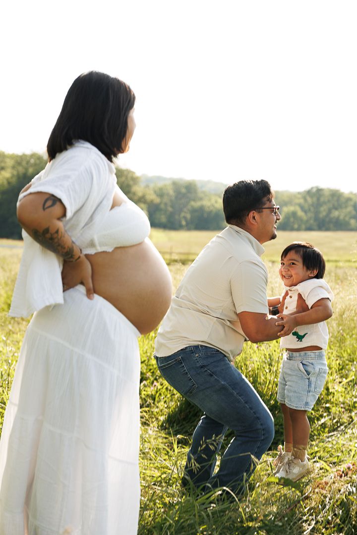 Series of candid shots in a grassy field showing casual white and denim outfits at sunset.