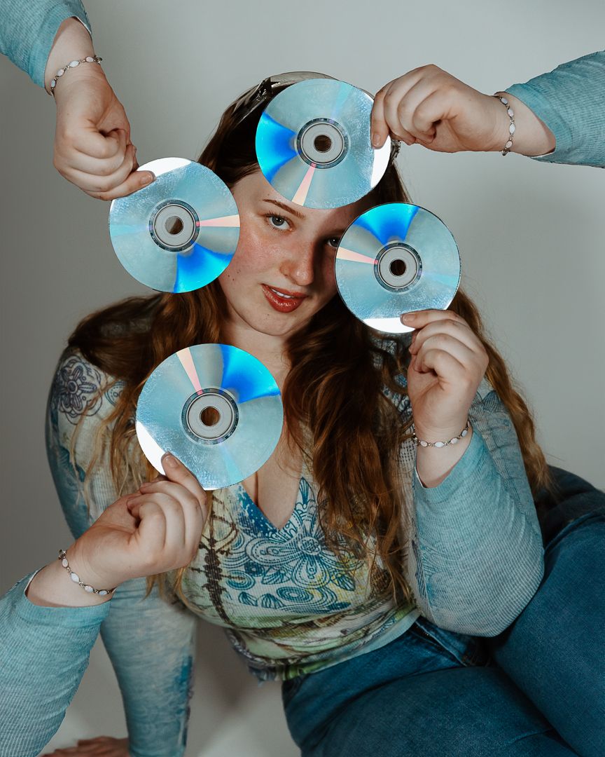 A sequence of playful poses showing someone holding shiny compact discs in front of their face against a light background.