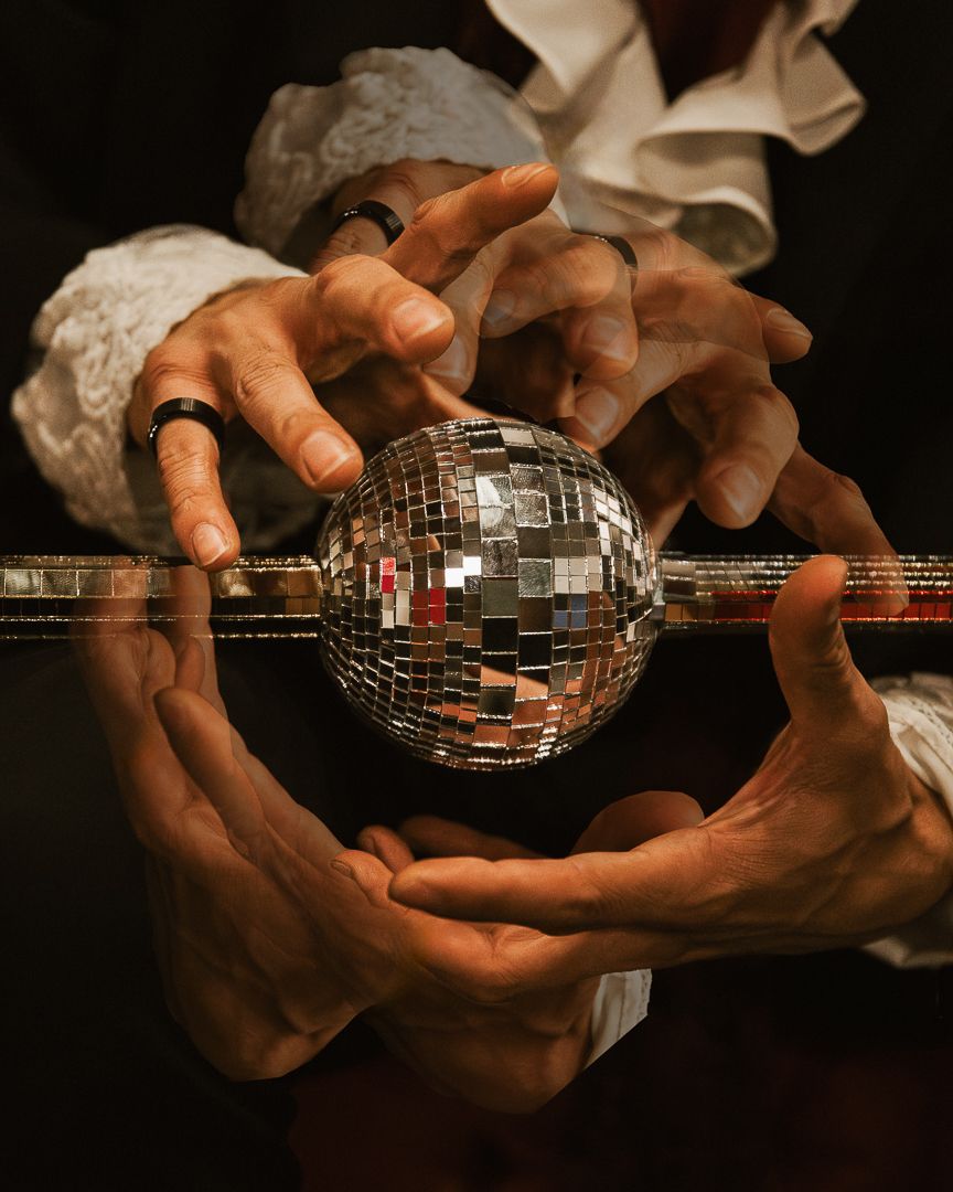 Hands gently cradle a shimmering disco ball ornament against a dark background in a series of artistic photographs.