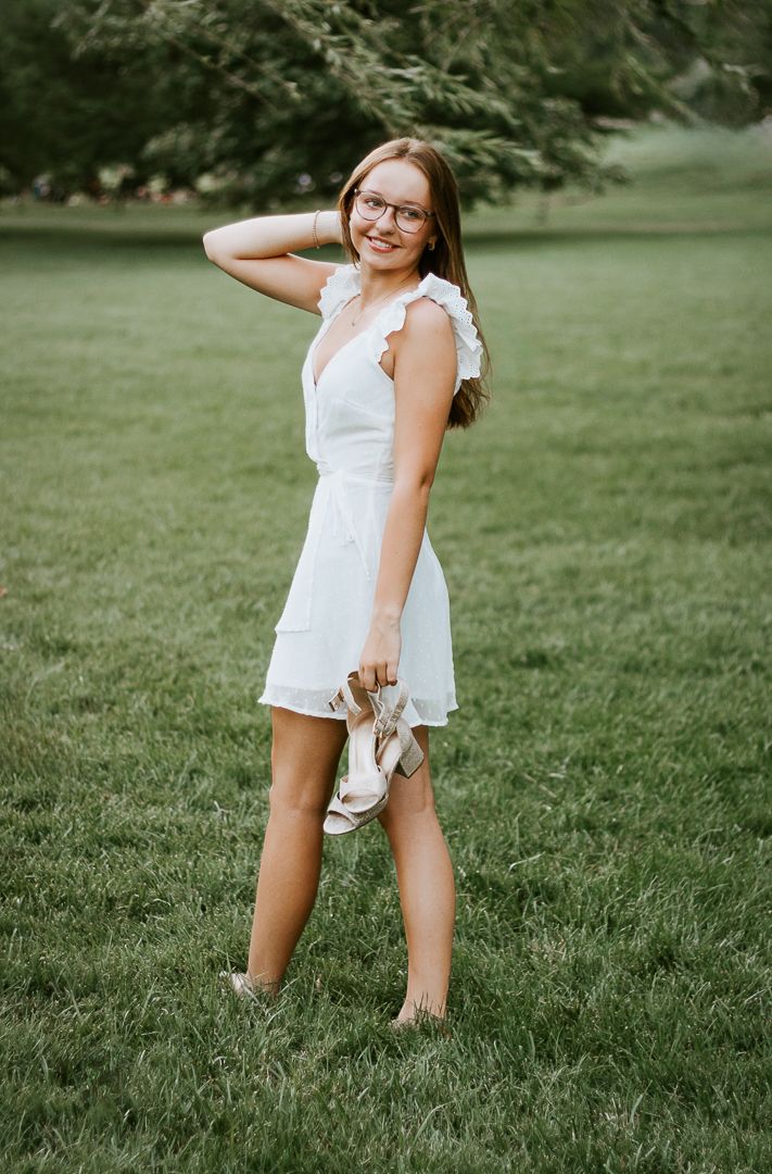 A candid photo series shows a playful moment on a summer lawn with movement and energy in white summer attire.