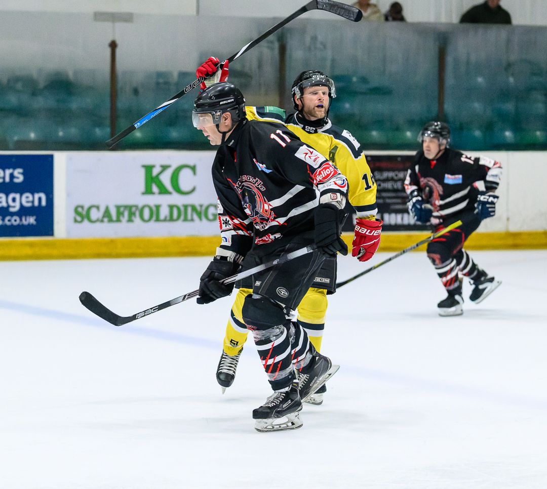 Ice hockey players skate onto the ice before a competitive match, ready for the opening face-off.