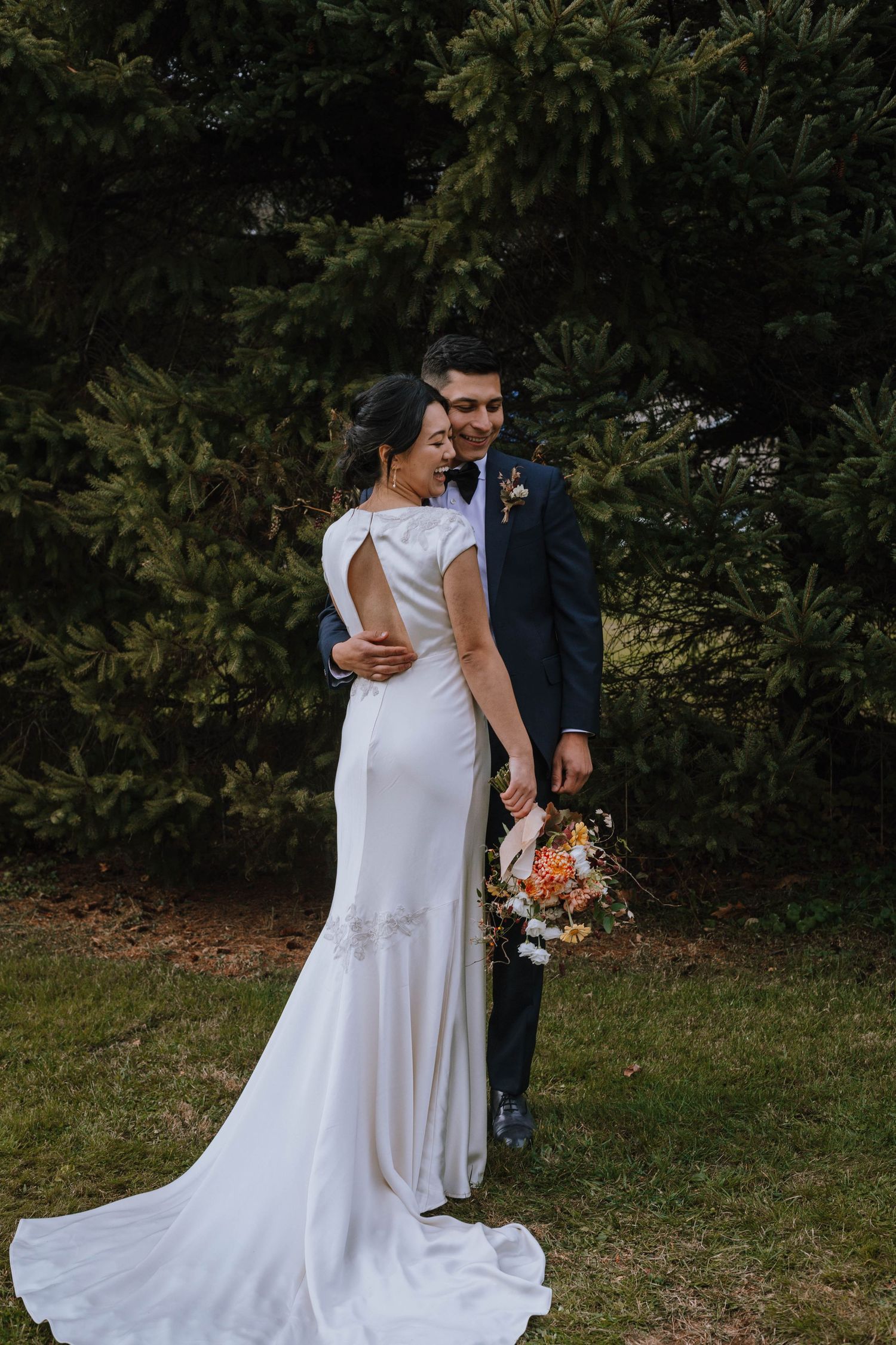 Bride and Groom laughing while holding each other