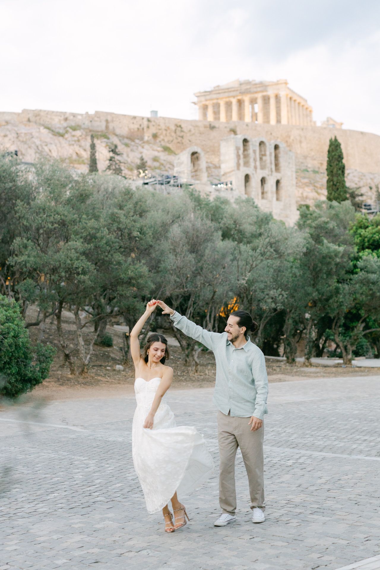 Couple photoshoot near Acropolis viewpoints in Athens, iconic backdrop in warm light.