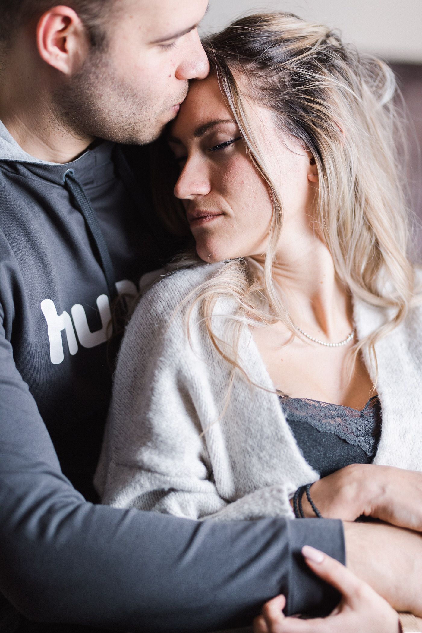 Private couple lifestyle session in a hotel or Airbnb, soft natural light and intimate mood.