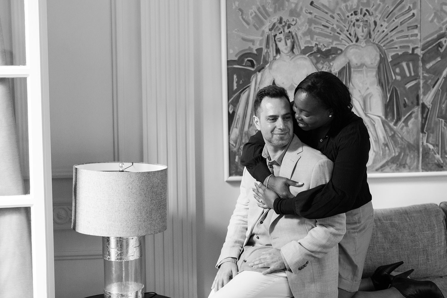 Private couple lifestyle session in an Athens hotel or Airbnb, soft natural light and intimate connection.