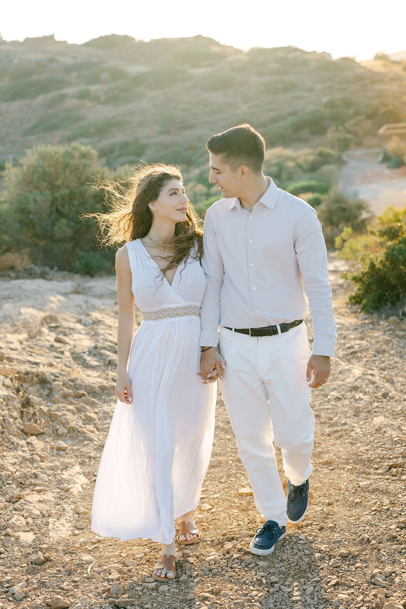 Athens Riviera photographer capturing couple portraits in soft sunset light.