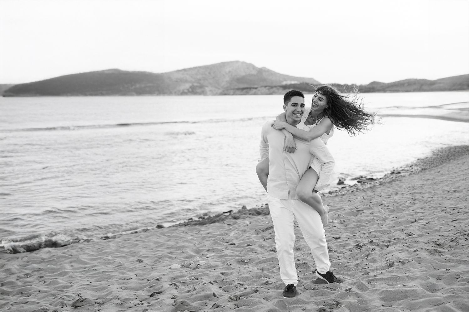 Couple embracing at golden hour in Athens, romantic editorial portrait in soft natural light.