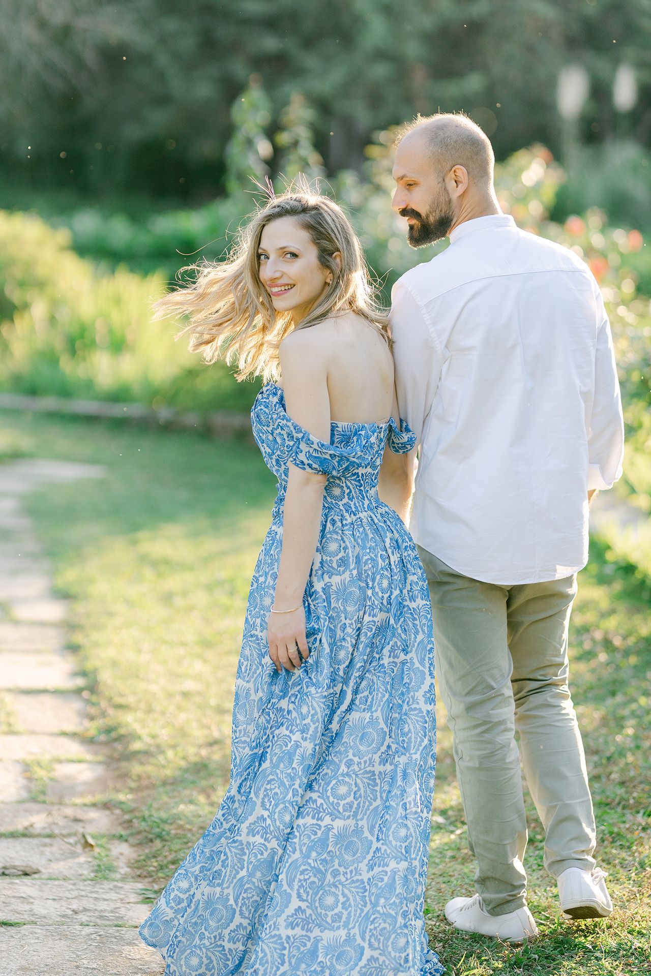Couple laughing during an Athens photoshoot, candid travel portrait moment in natural light.