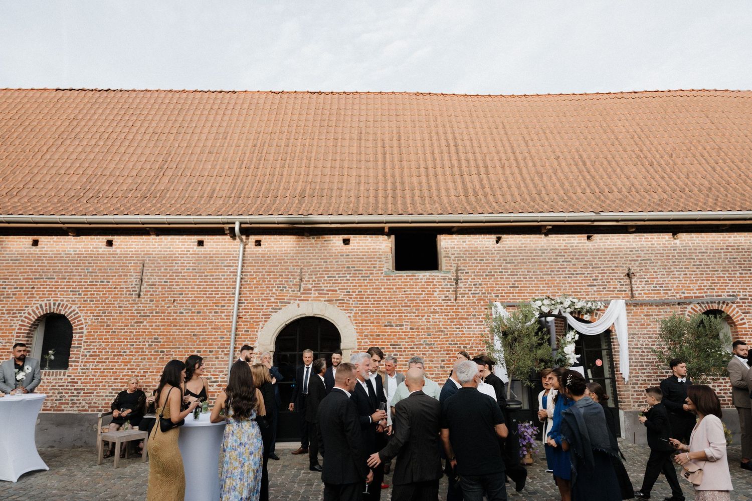documentary wedding photography in switzerland, reception in a fancy restaurant with laughter love and joy. guests enjoying cocktails. price