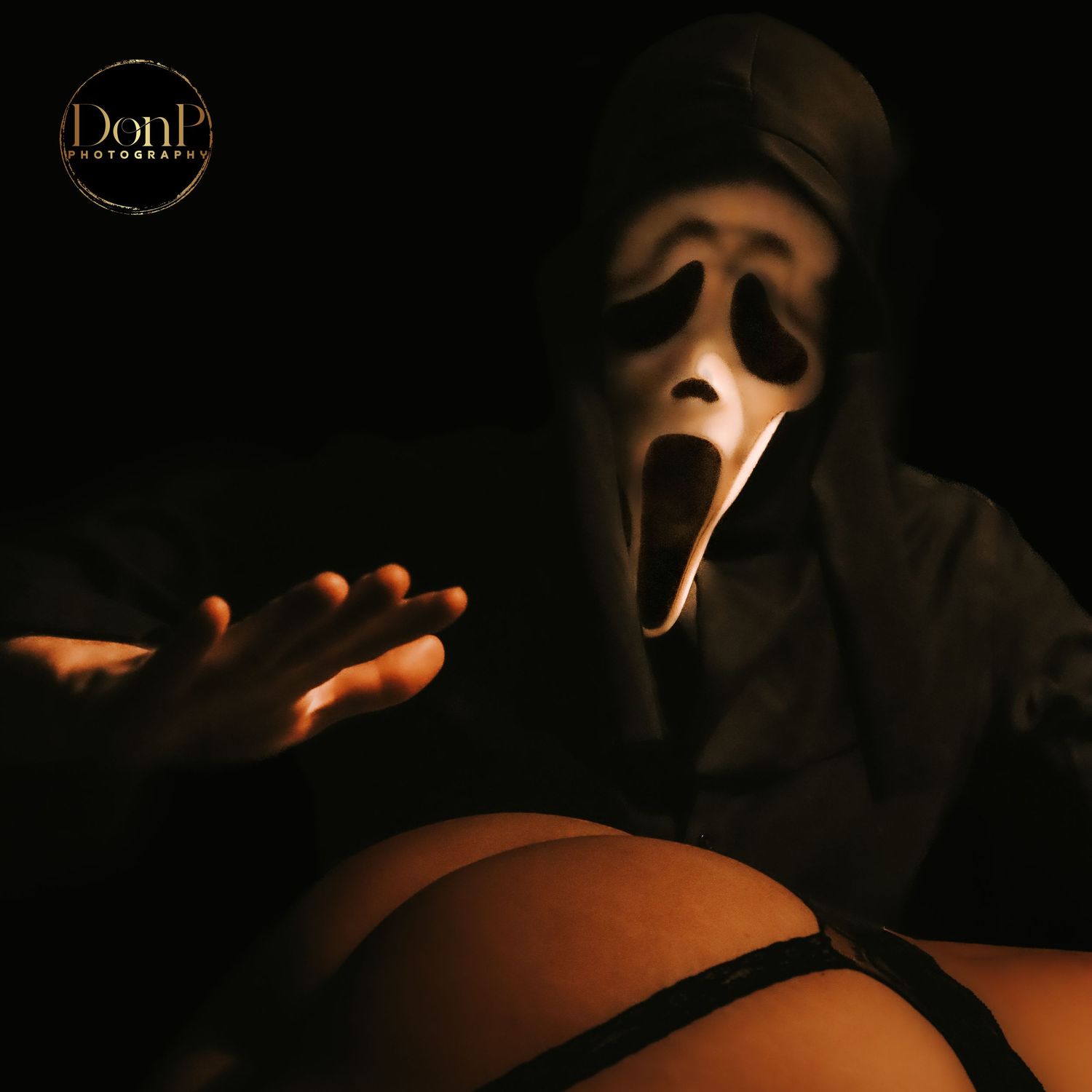 Conceptual boudoir photography portrait with a masked figure and expressive gesture, exploring tension, mystery, and presence.