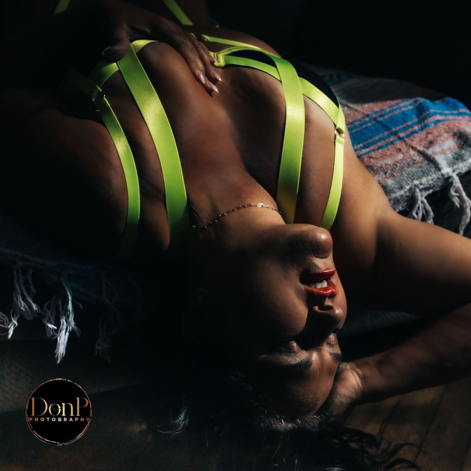 Dramatic low-light portrait of a reclining figure with graphic styling, emphasizing contrast, emotion, and cinematic mood.