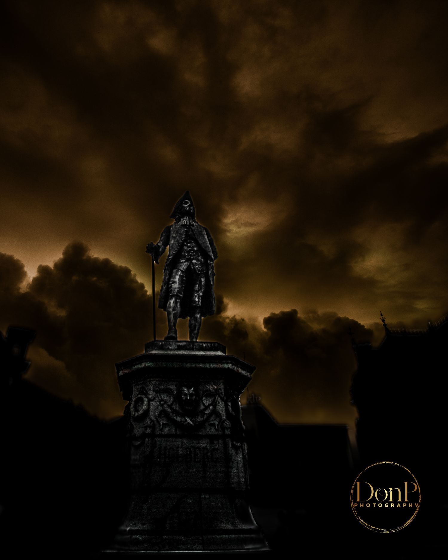 Dark, moody photograph of a historic statue silhouetted against stormy clouds, reflecting themes of presence, time, and artistic perspective