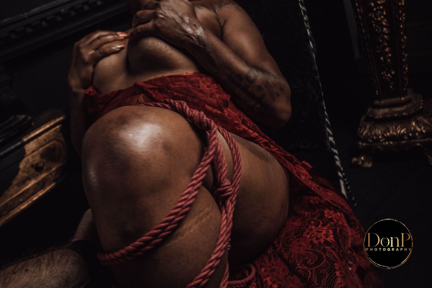 Low-light boudoir photography detail portrait highlighting texture and form, with shadow used to create depth and intimacy.