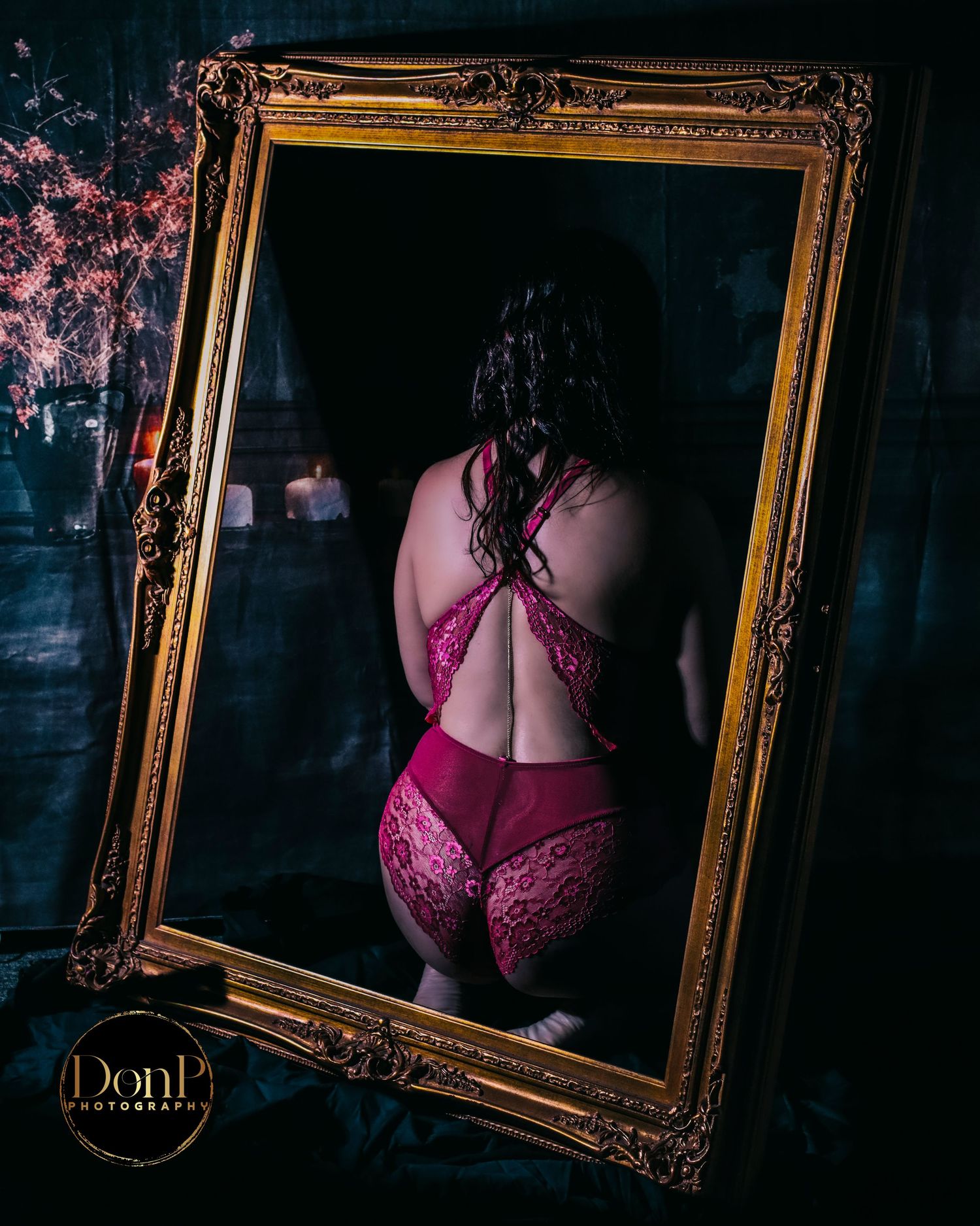 Conceptual studio portrait using a framed mirror and soft pink styling to explore reflection, form, and identity.