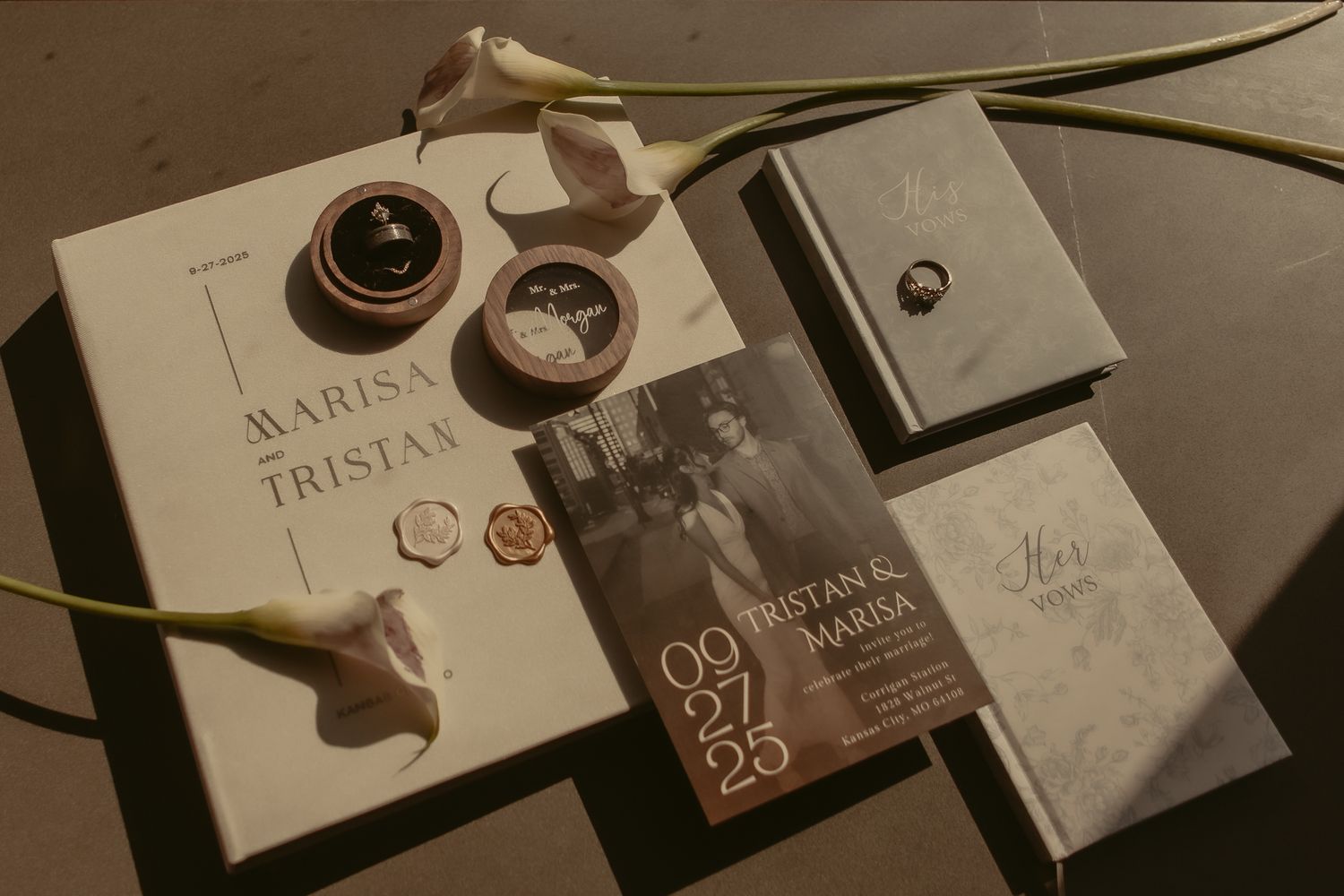 Elegant wedding stationery flatlay for Marisa and Tristan featuring rings, wax seals, and invitations.