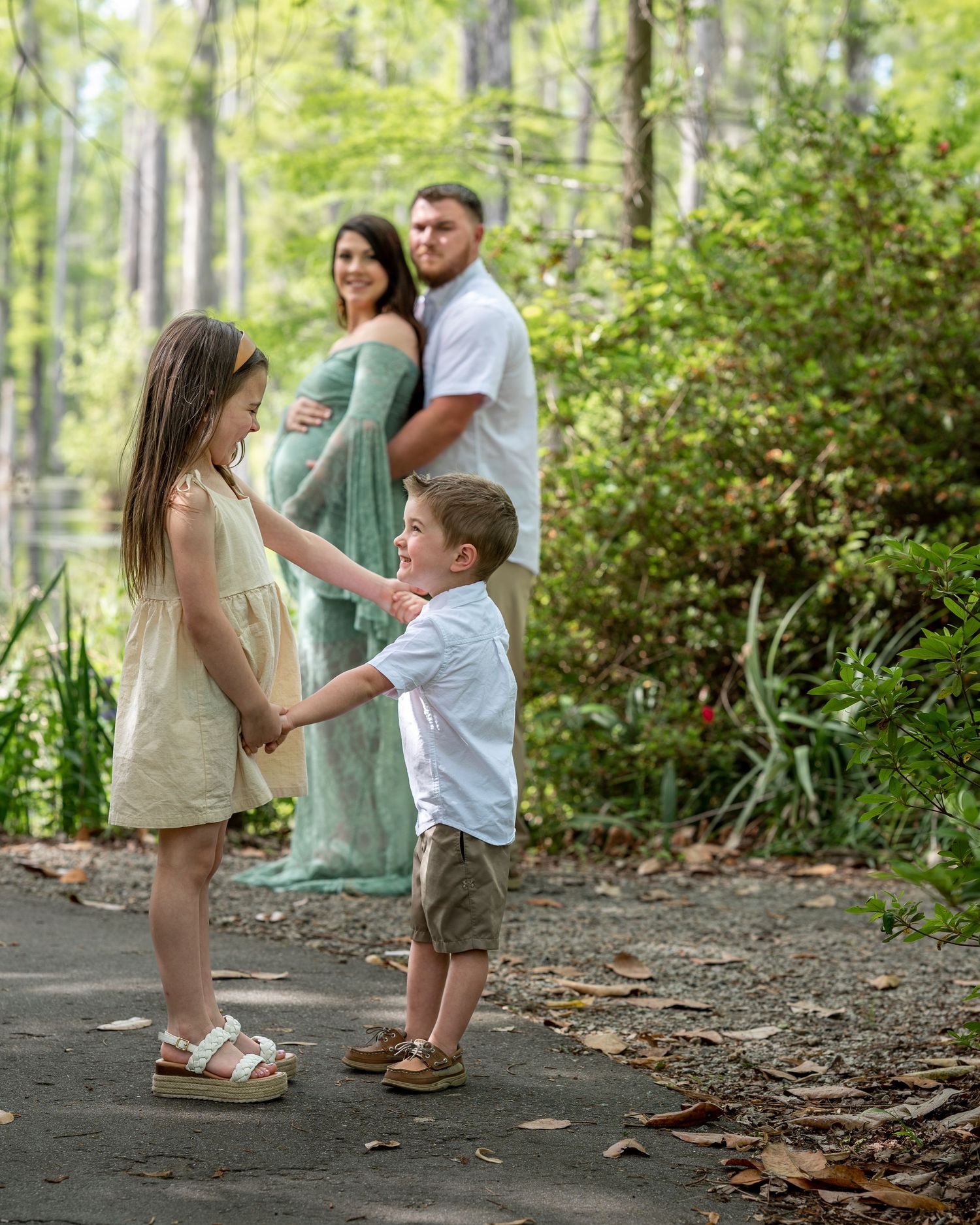 Megan and Mark embrace as their children stand in front of them dancing