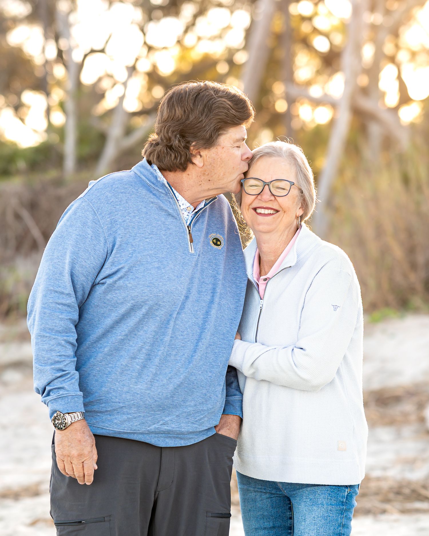 A tender moment shared outdoors during golden hour.