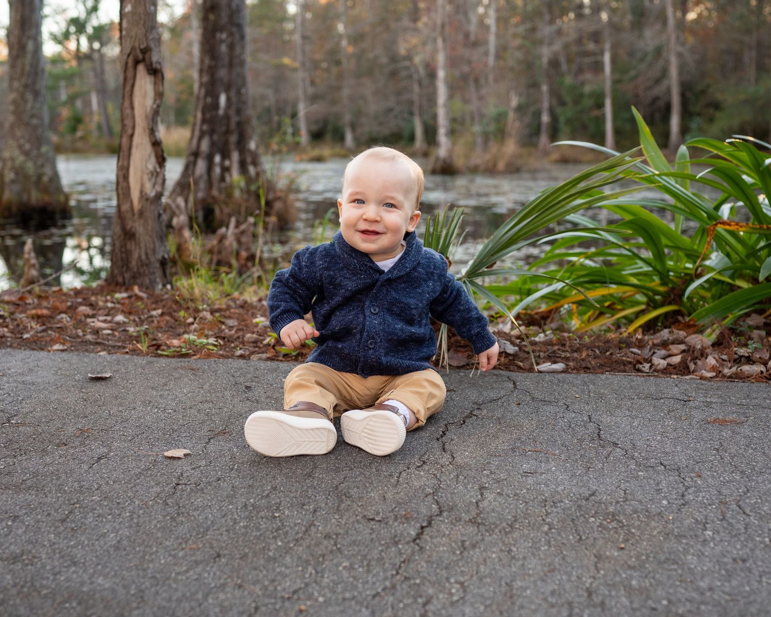 One year old Billy sits along the path at Cypress Gardens