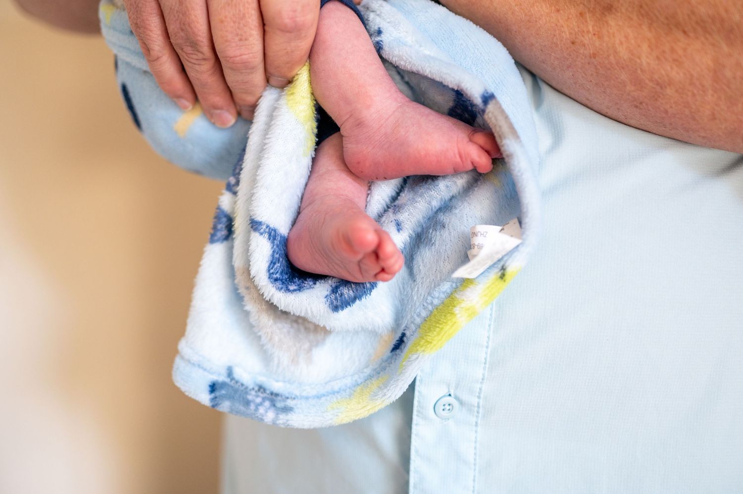 Close up of baby feet wrapped in a blanket