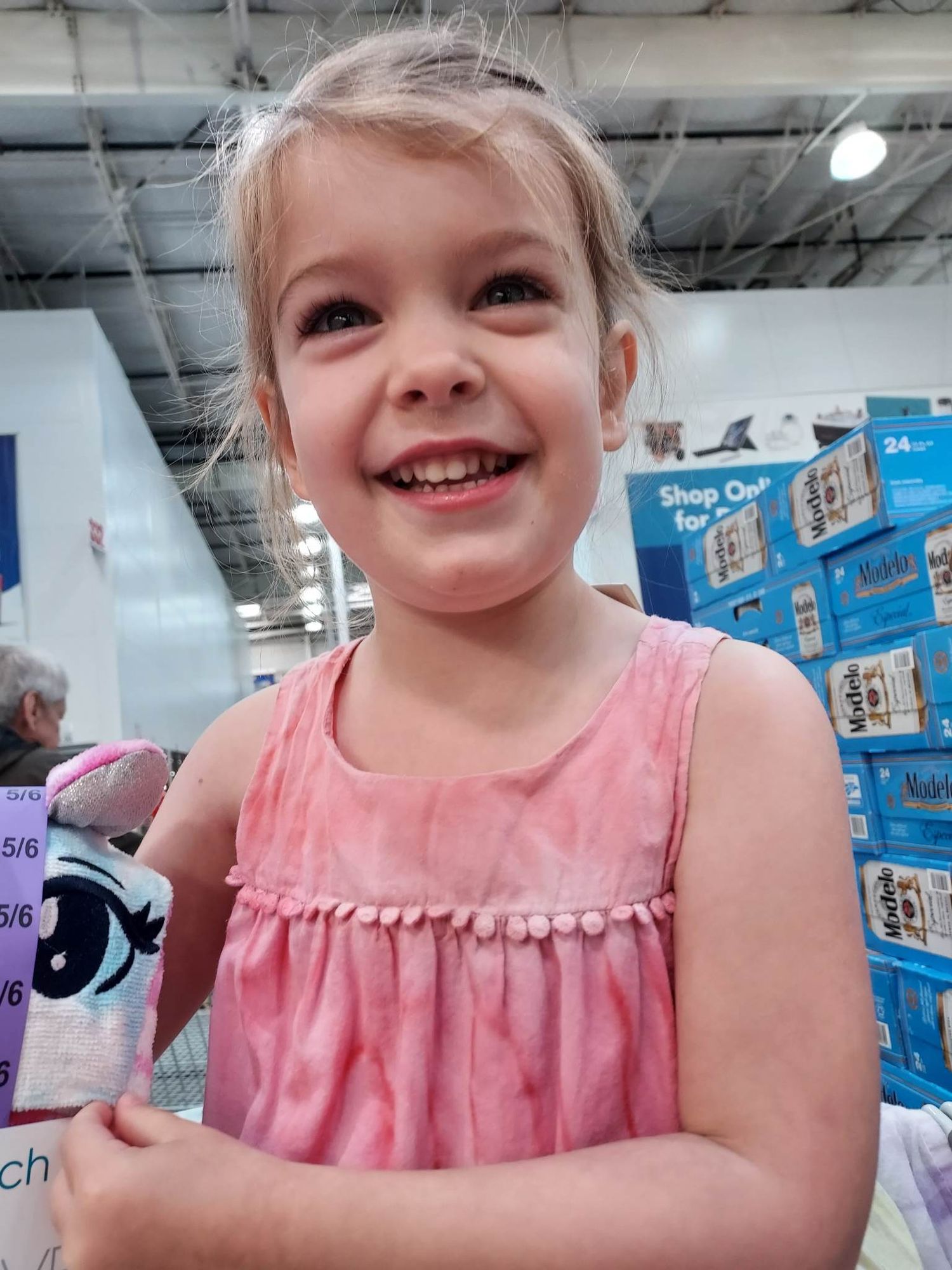 Four year old Jenny sits with a toy with a photo taken below