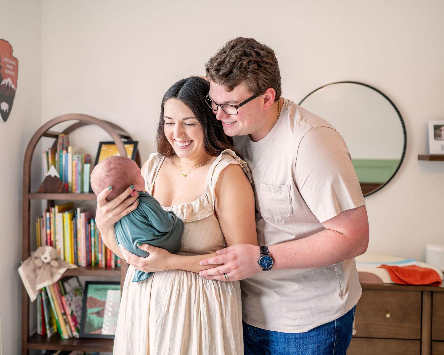 Intimate indoor lifestyle photography session capturing precious early moments with a newborn.